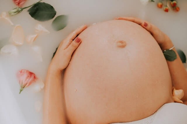 pregnant woman sitting on bathtub 3094435